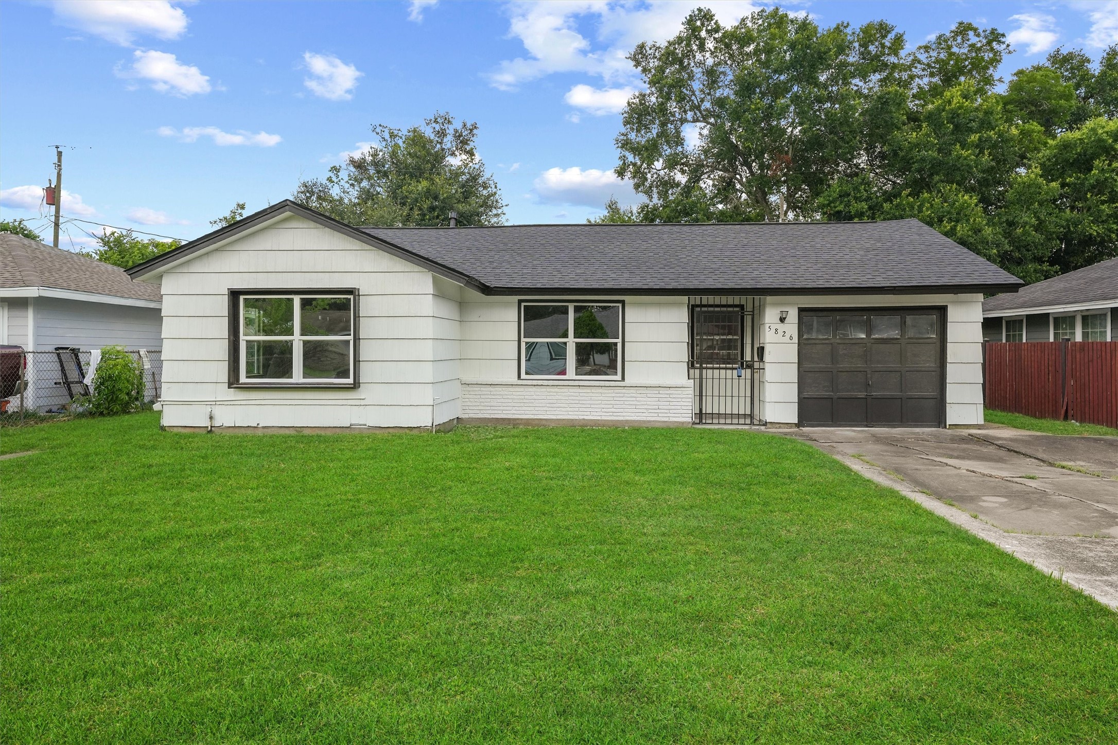 5826 Belmark Street Houston, TX 77033 - Photo 1 of 15 a front view of house with yard and green space