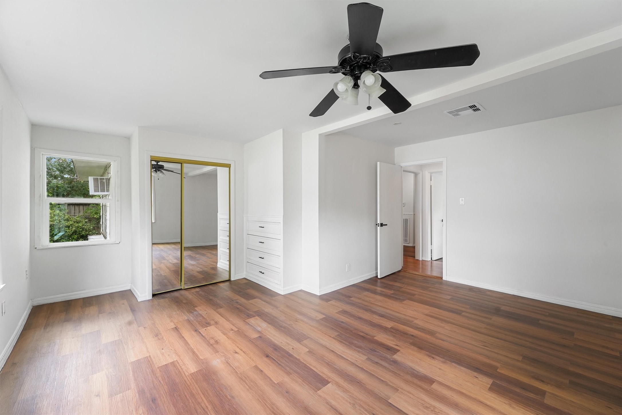 5826 Belmark Street Houston, TX 77033 - Photo 11 of 15 a view of empty room with wooden floor and fan