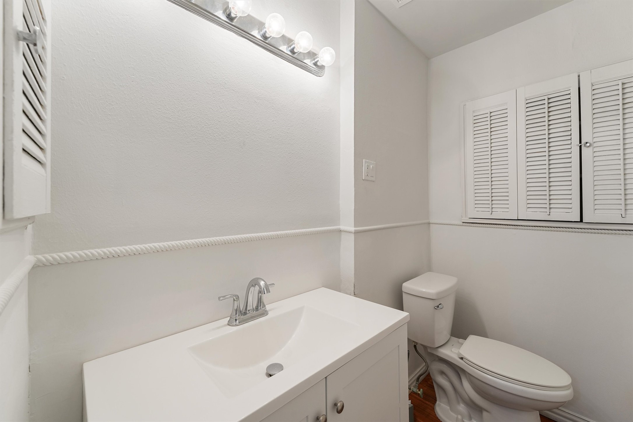 5826 Belmark Street Houston, TX 77033 - Photo 12 of 15 a bathroom with a sink a toilet and vanity