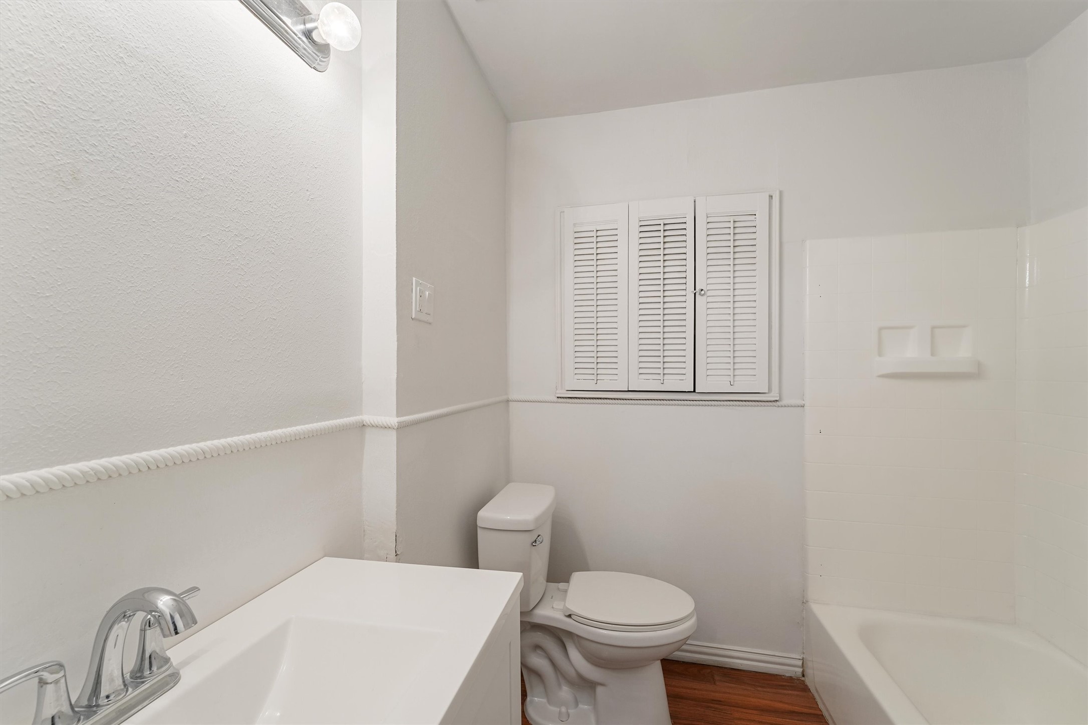 5826 Belmark Street Houston, TX 77033 - Photo 13 of 15 a white toilet sitting next to a bathroom sink