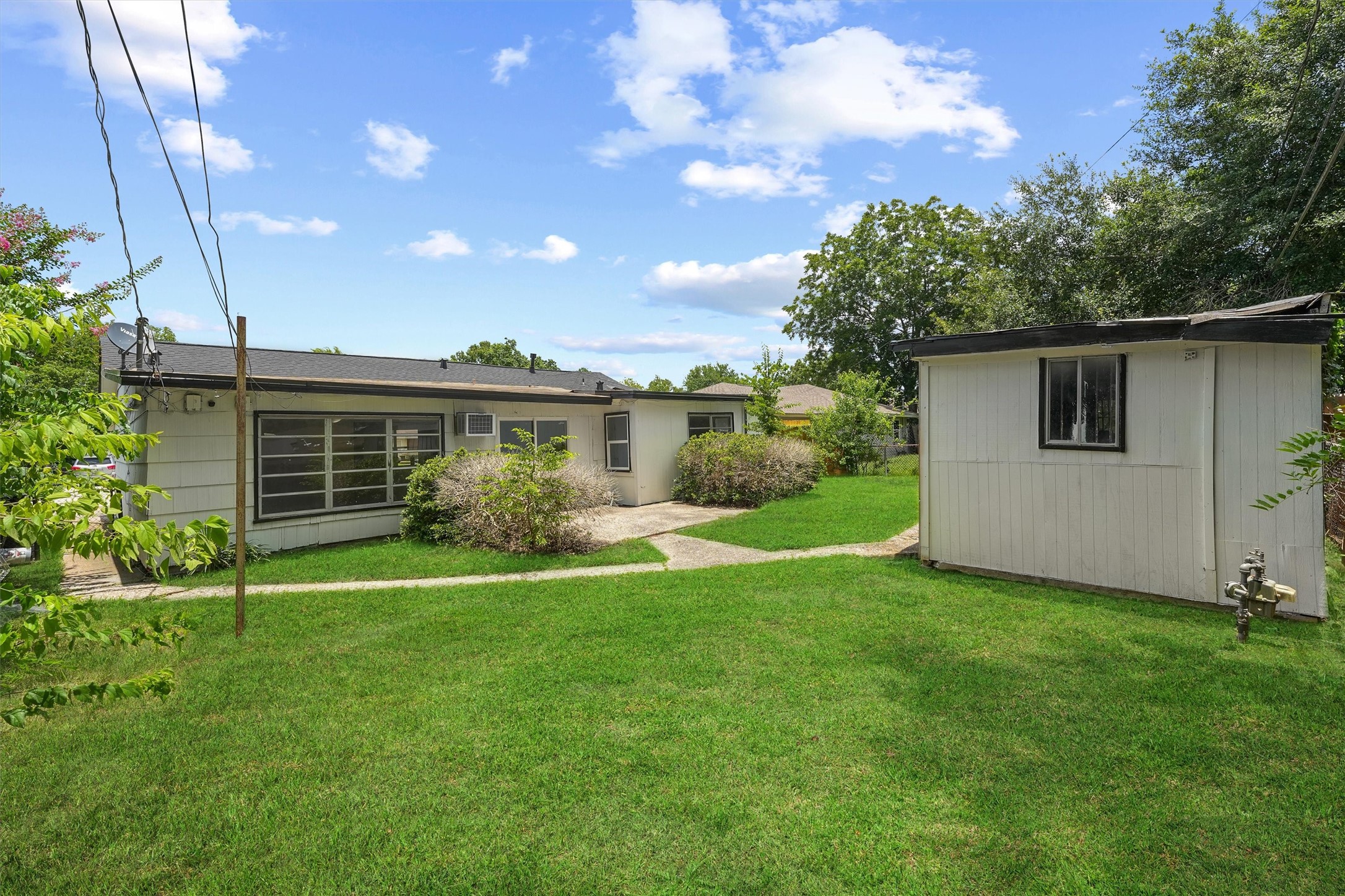 5826 Belmark Street Houston, TX 77033 - Photo 15 of 15 a view of a house with backyard and garden