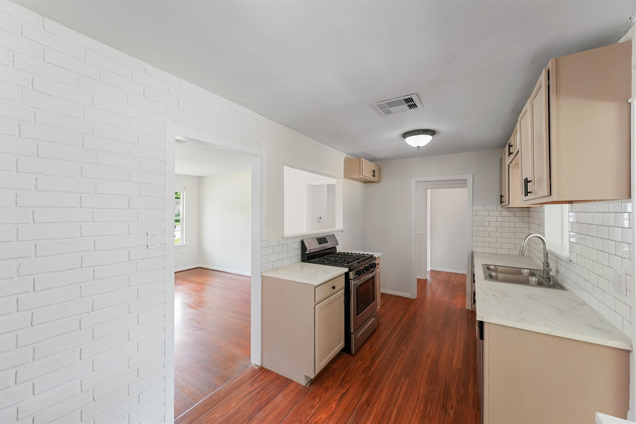 5826 Belmark Street Houston, TX 77033 - Photo 5 of 15 a kitchen with stainless steel appliances granite countertop a stove and a sink