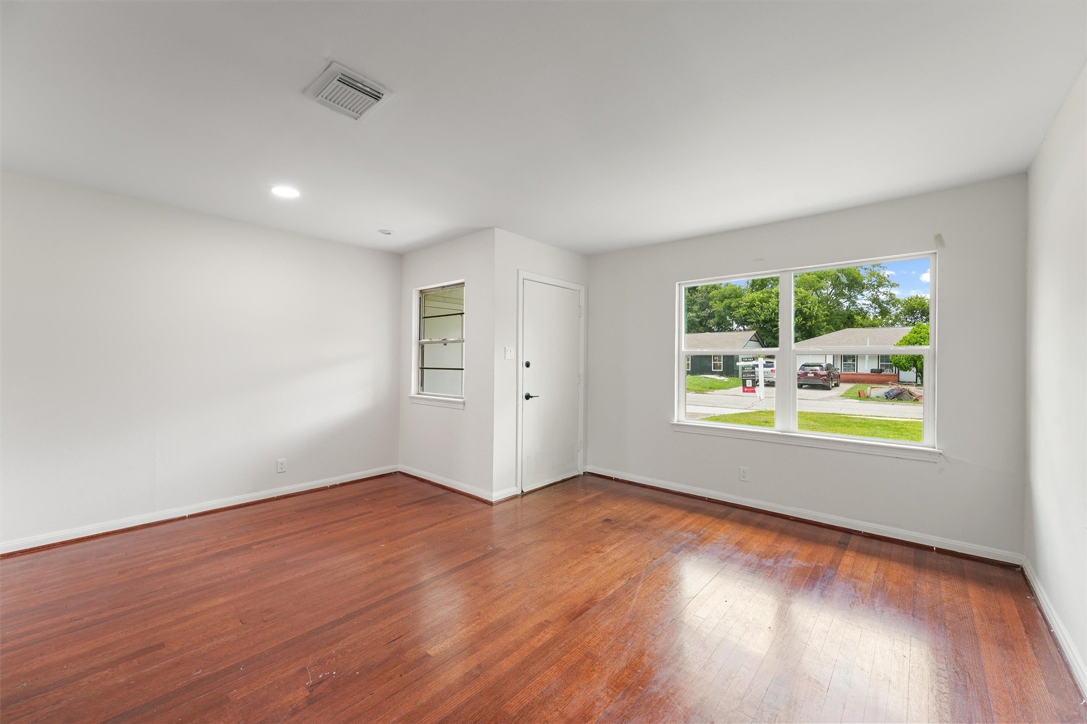5826 Belmark Street Houston, TX 77033 - Photo 7 of 15 wooden floor in an empty room with a window