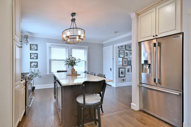 a view of a dining room with furniture wooden floor and a chandelier