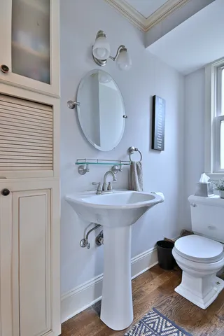 a bathroom with a sink toilet and mirror