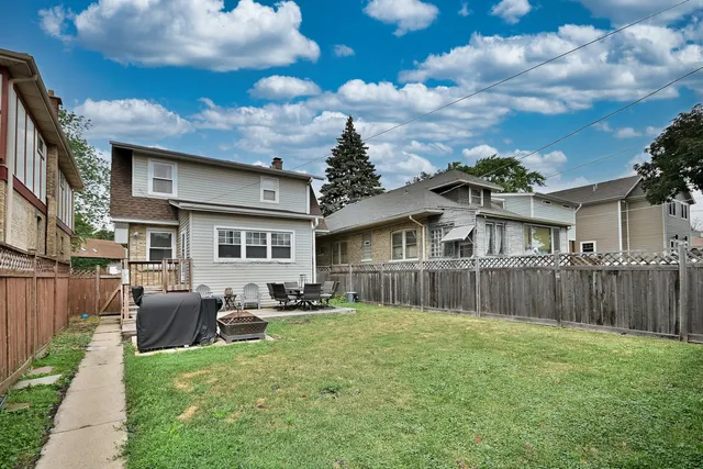 a view of a backyard with sitting area