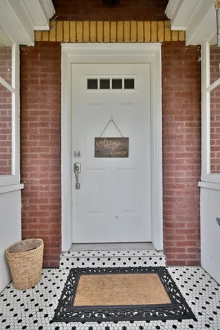 a view of a brick house with potted plants
