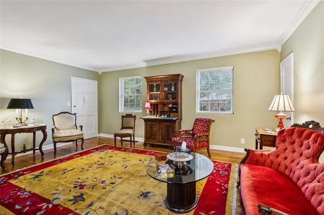 a living room with furniture a rug and a lamp