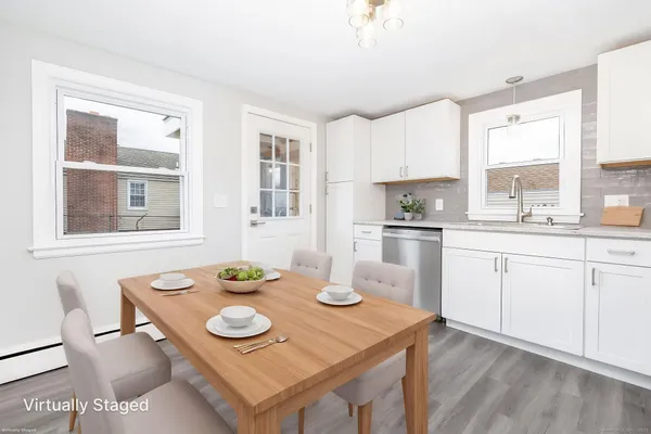 a kitchen with white cabinets and white appliances