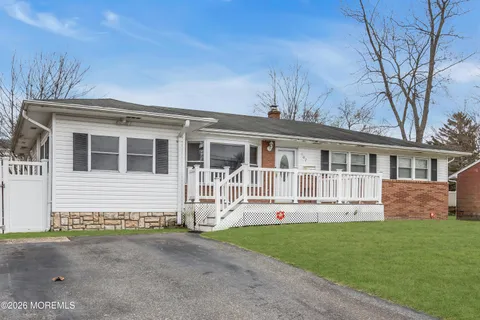 a front view of a house with a garden and yard