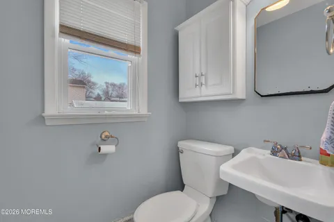 a white toilet sitting next to a bathroom sink