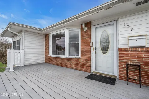 a view of a house with wooden deck