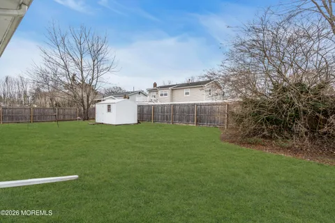 a view of a backyard with large trees