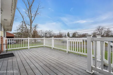 a balcony with wooden floor and fence