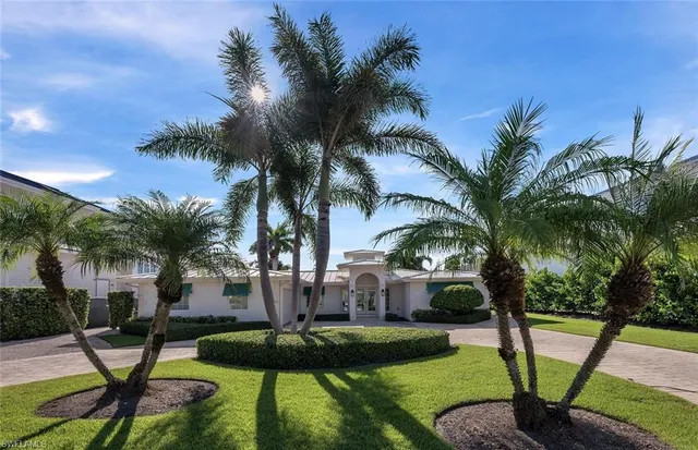 a view of a backyard with swimming pool and furniture