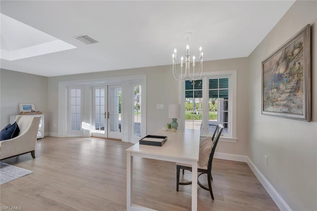 1925 Tarpon Road Naples, FL 34102 - Photo 11 of 41 a dining room with furniture a chandelier and wooden floor