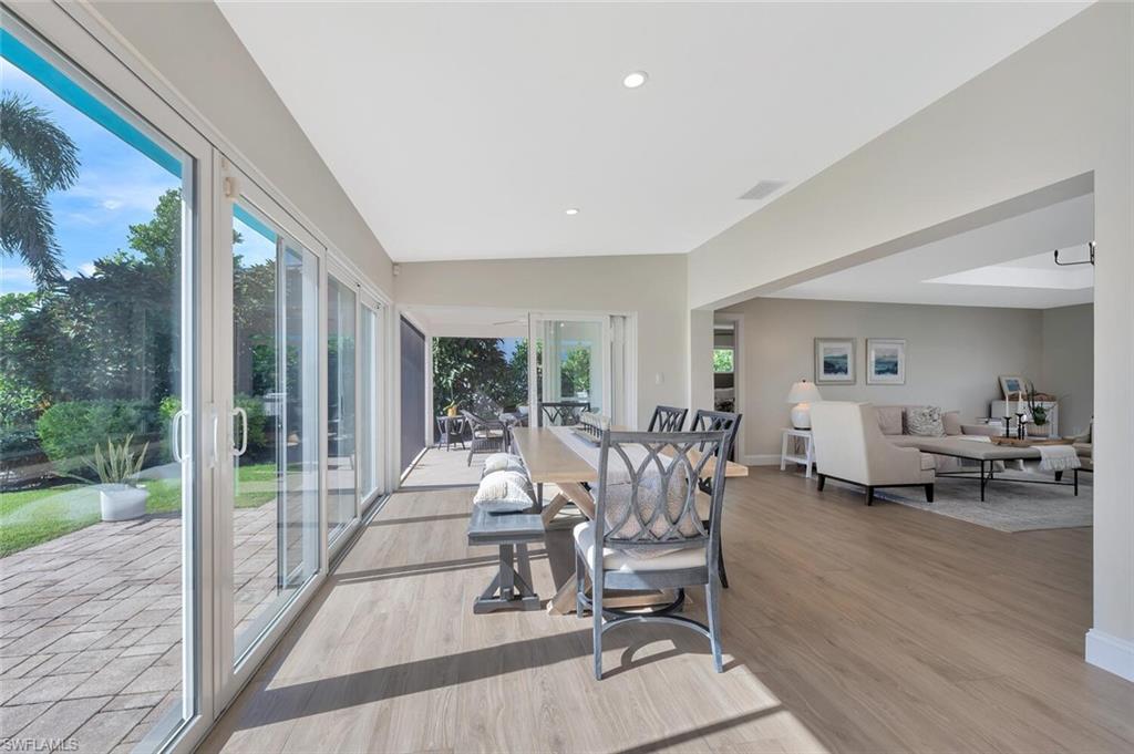 1925 Tarpon Road Naples, FL 34102 - Photo 13 of 41 a living room with patio furniture and a floor to ceiling window