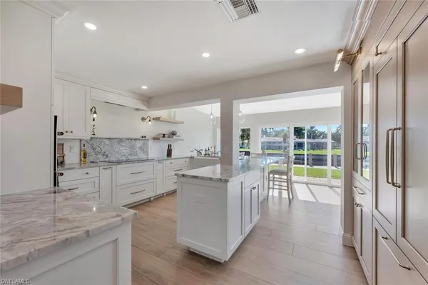 a kitchen with counter top space and living room
