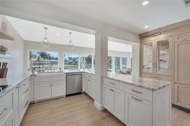 a large white kitchen with a window