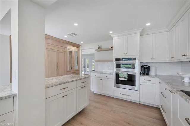 a kitchen with white cabinets and white appliances