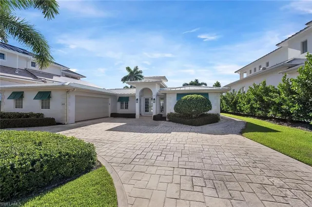 a front view of a house with a yard and a garage