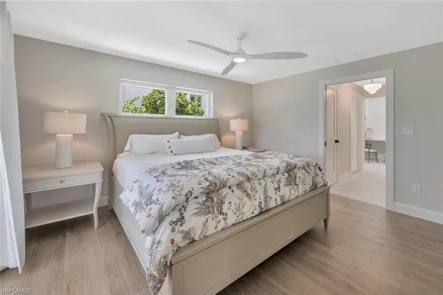 a bedroom with a bed and a night stand