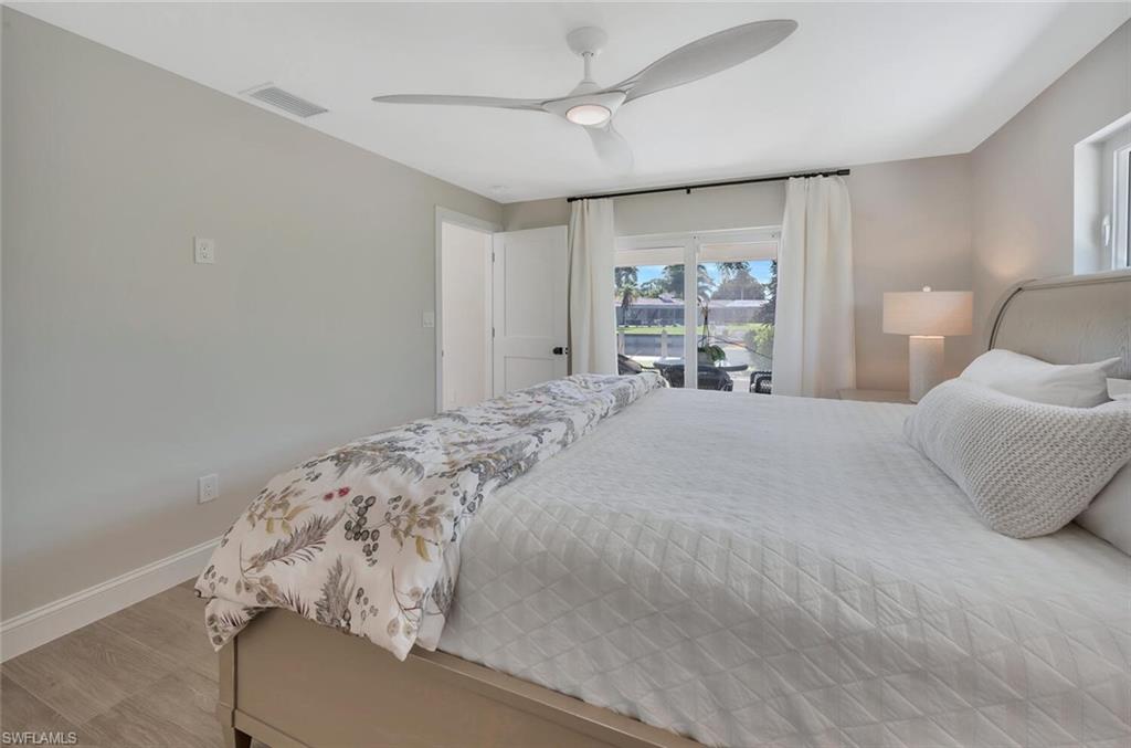 1925 Tarpon Road Naples, FL 34102 - Photo 22 of 41 a bedroom with a large bed and a window