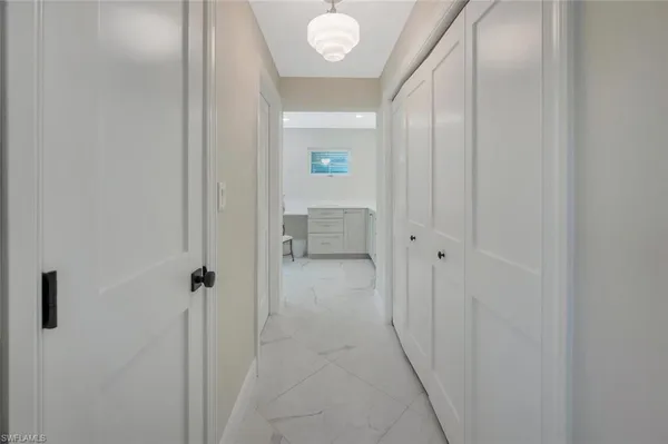 a view of a hallway with wooden floor