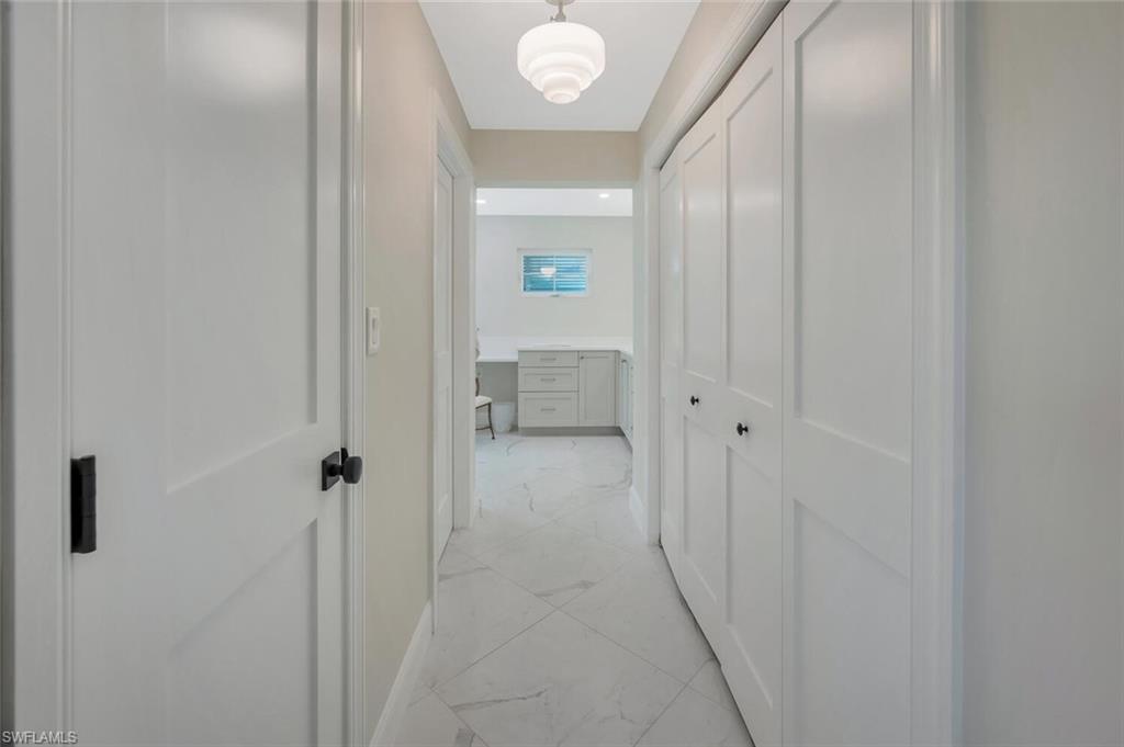 1925 Tarpon Road Naples, FL 34102 - Photo 23 of 41 a view of a hallway with wooden floor
