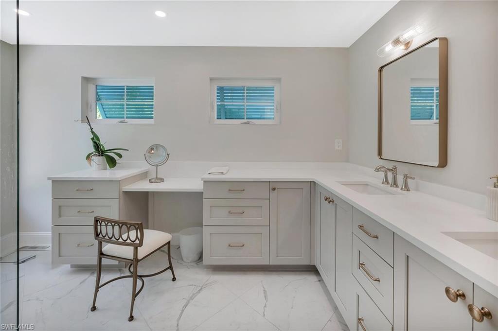 1925 Tarpon Road Naples, FL 34102 - Photo 24 of 41 a bathroom with a sink and a mirror