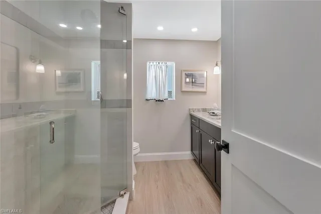 a bathroom with a sink a toilet and shower