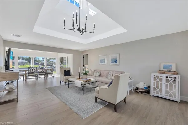 a living room with furniture ceiling fan and a wooden floor
