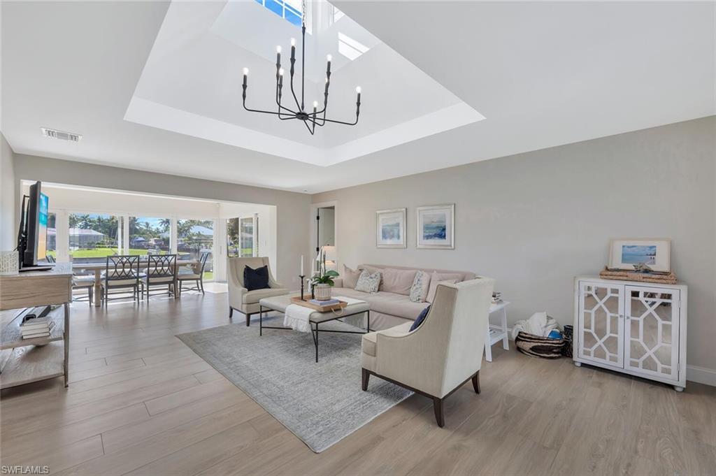 1925 Tarpon Road Naples, FL 34102 - Photo 3 of 41 a living room with furniture ceiling fan and a wooden floor