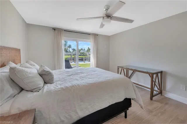 a bedroom with a bed window and a dresser