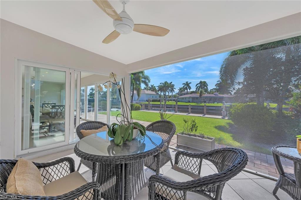 1925 Tarpon Road Naples, FL 34102 - Photo 35 of 41 a living room with furniture and a large window