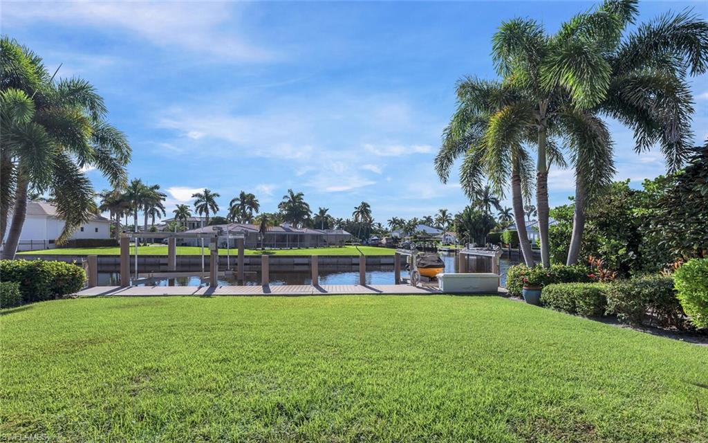 1925 Tarpon Road Naples, FL 34102 - Photo 36 of 41 a view of a swimming pool with lawn chairs and a big yard