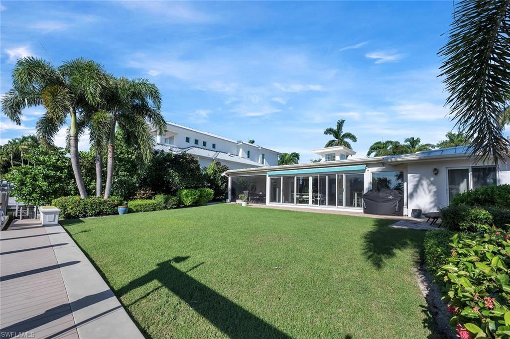 1925 Tarpon Road Naples, FL 34102 - Photo 38 of 41 a front view of a house with a garden and plants