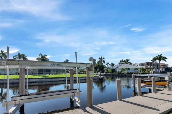 a view of a house with outdoor space and a lake view