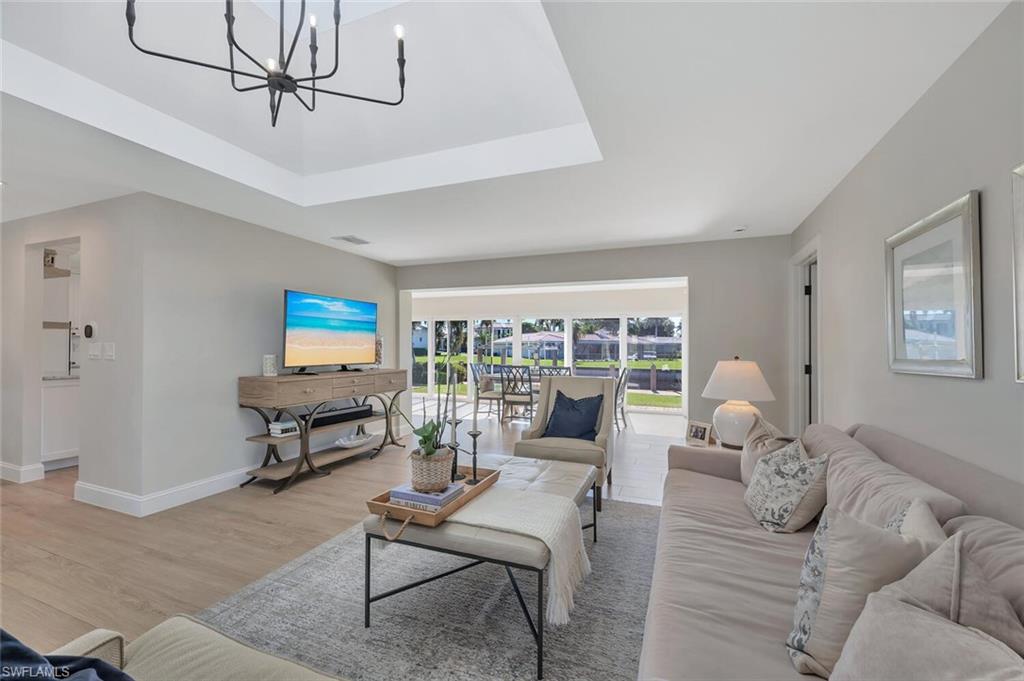 1925 Tarpon Road Naples, FL 34102 - Photo 4 of 41 a living room with furniture and a flat screen tv