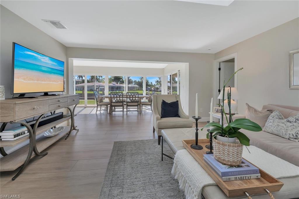 1925 Tarpon Road Naples, FL 34102 - Photo 5 of 41 a living room with furniture and a flat screen tv