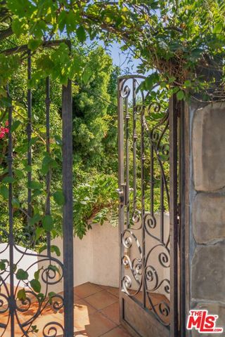a view of a chairs and table in the back yard of the house