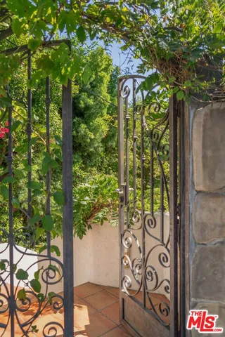 a view of a chairs and table in the back yard of the house