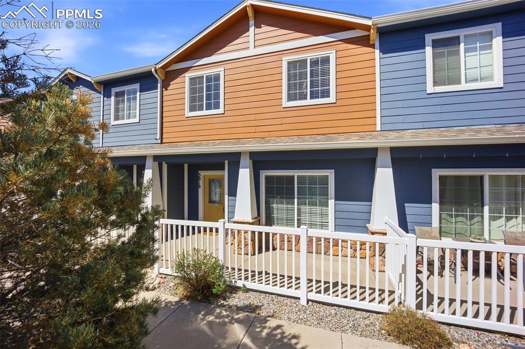 3019 Shikra View Colorado Springs, CO 80916 - Photo 1 of 42 a front view of a house with a porch