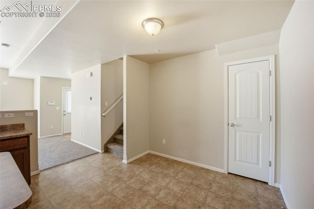 3019 Shikra View Colorado Springs, CO 80916 - Photo 11 of 42 an empty room with a fireplace and a view of bathroom