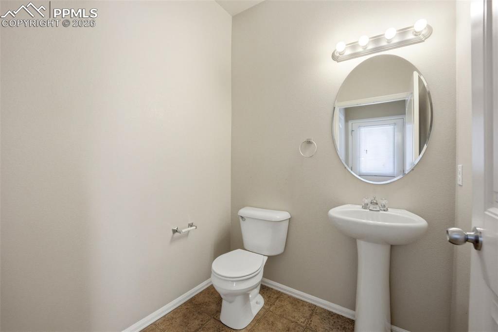 3019 Shikra View Colorado Springs, CO 80916 - Photo 12 of 42 a bathroom with a toilet sink and mirror
