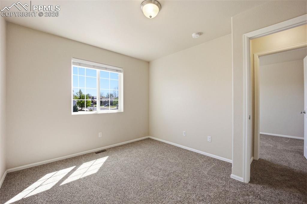 3019 Shikra View Colorado Springs, CO 80916 - Photo 22 of 42 an empty room with windows and closet