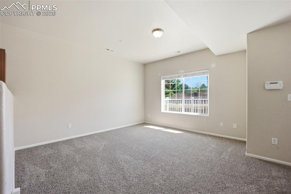 3019 Shikra View Colorado Springs, CO 80916 - Photo 4 of 42 an empty room with windows