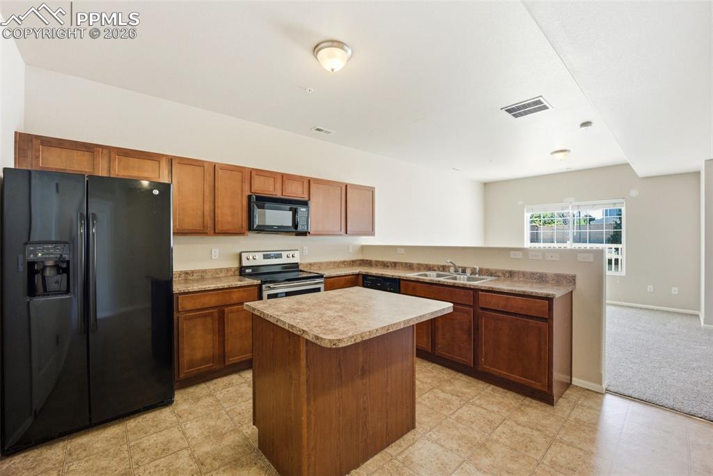 3019 Shikra View Colorado Springs, CO 80916 - Photo 9 of 42 a kitchen with stainless steel appliances granite countertop a stove a refrigerator and a sink