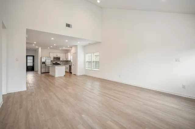 a view of a kitchen with a refrigerator and a window