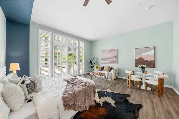 a bedroom with furniture and a large window